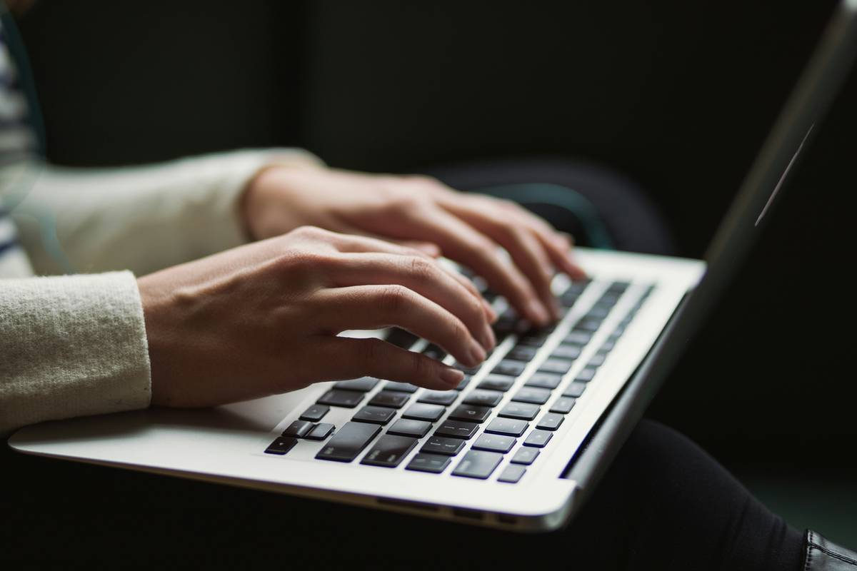 Individual using password managers for individuals on smartphone and laptop simultaneously