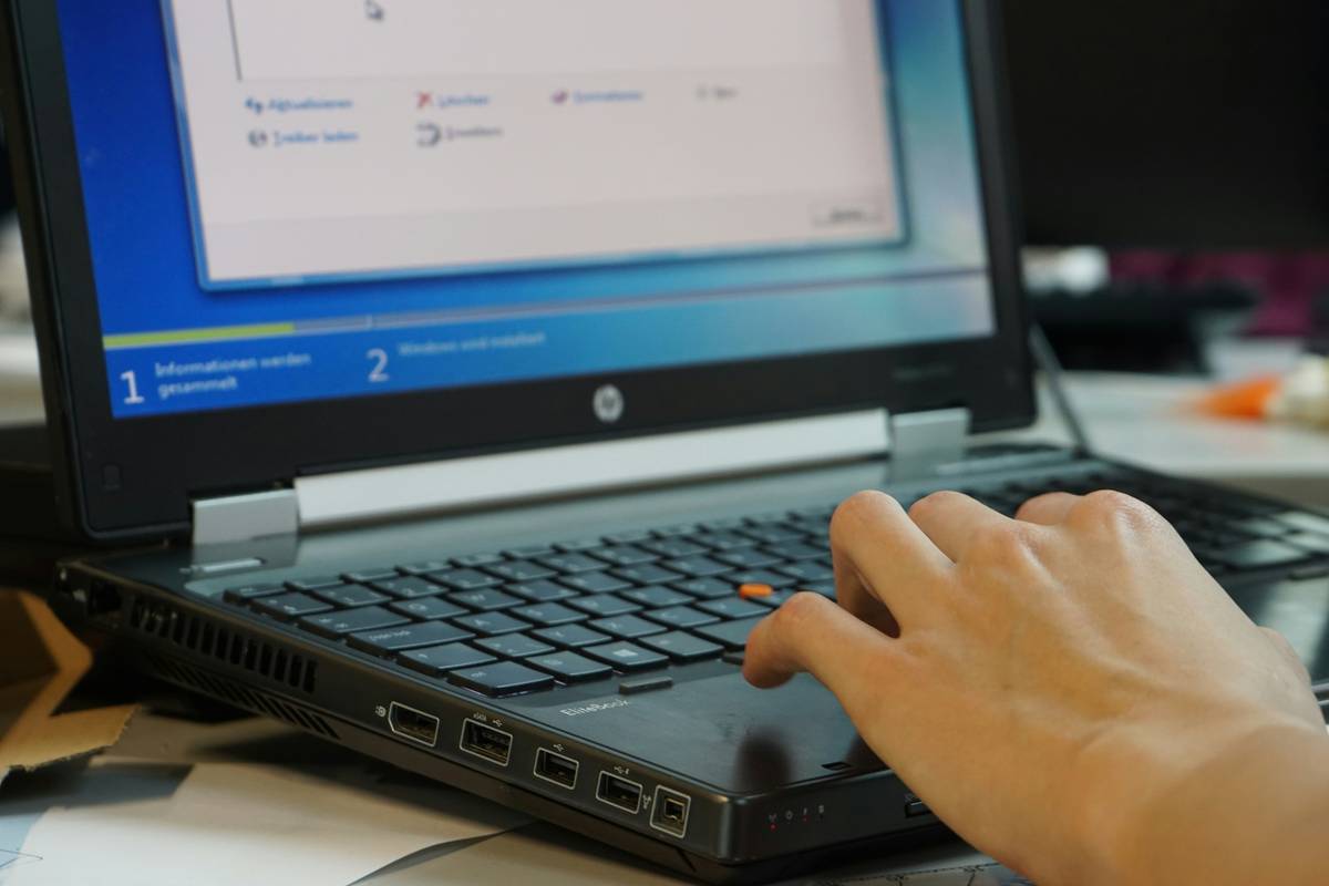 Cyber security project manager certification being held by professional reviewing password manager dashboard